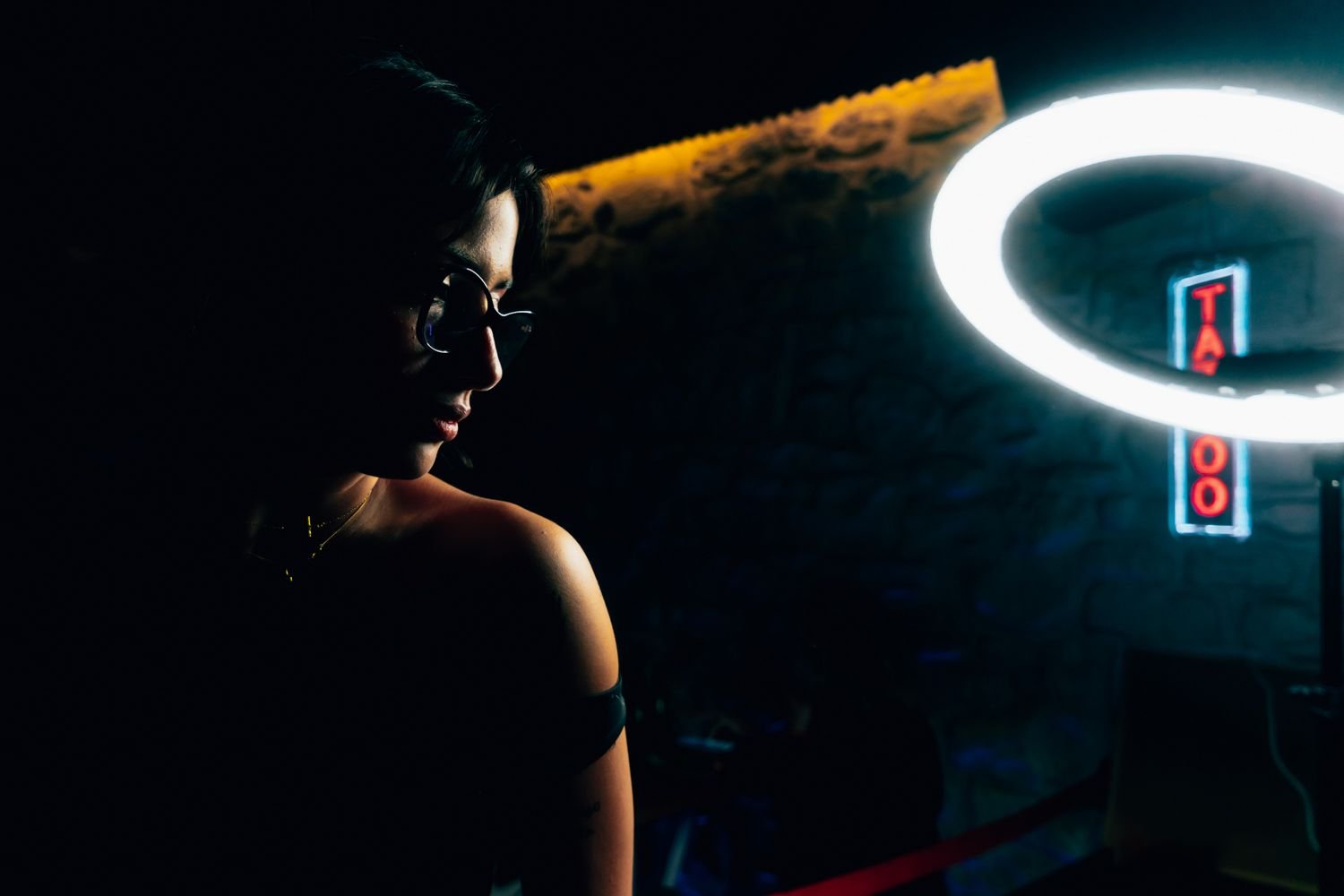 Producción de retrato frente a un aro de luz en un estudio de tatuaje